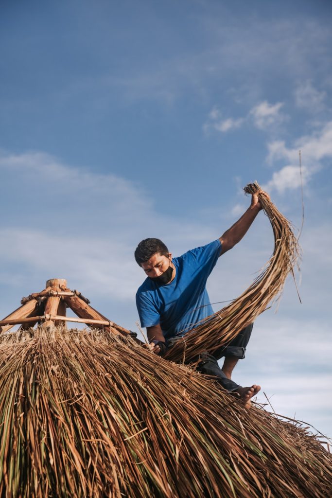 Significant Declines in Labor Productivity Across Several States man in blue polo shirt and brown pants sitting on brown woven hammock during daytime