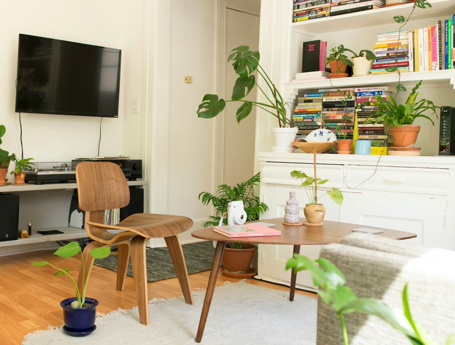Interior Designer Reveals Biggest Summer Décor Mistake to Avoid brown wooden table and chair beside bookshelf