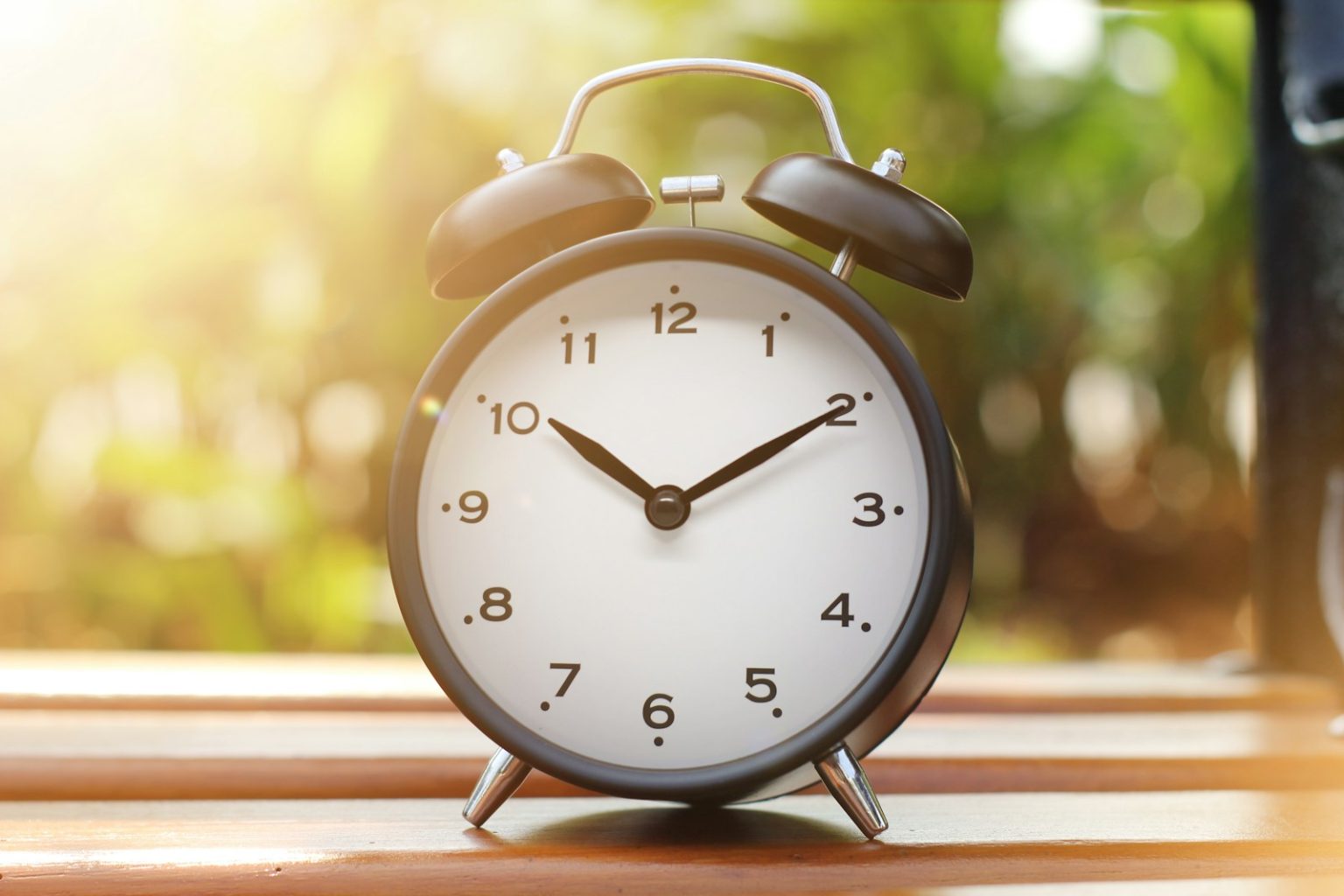Syrac Inspirations’ Top 6 Success Skills for Any Field an alarm clock sitting on top of a wooden table