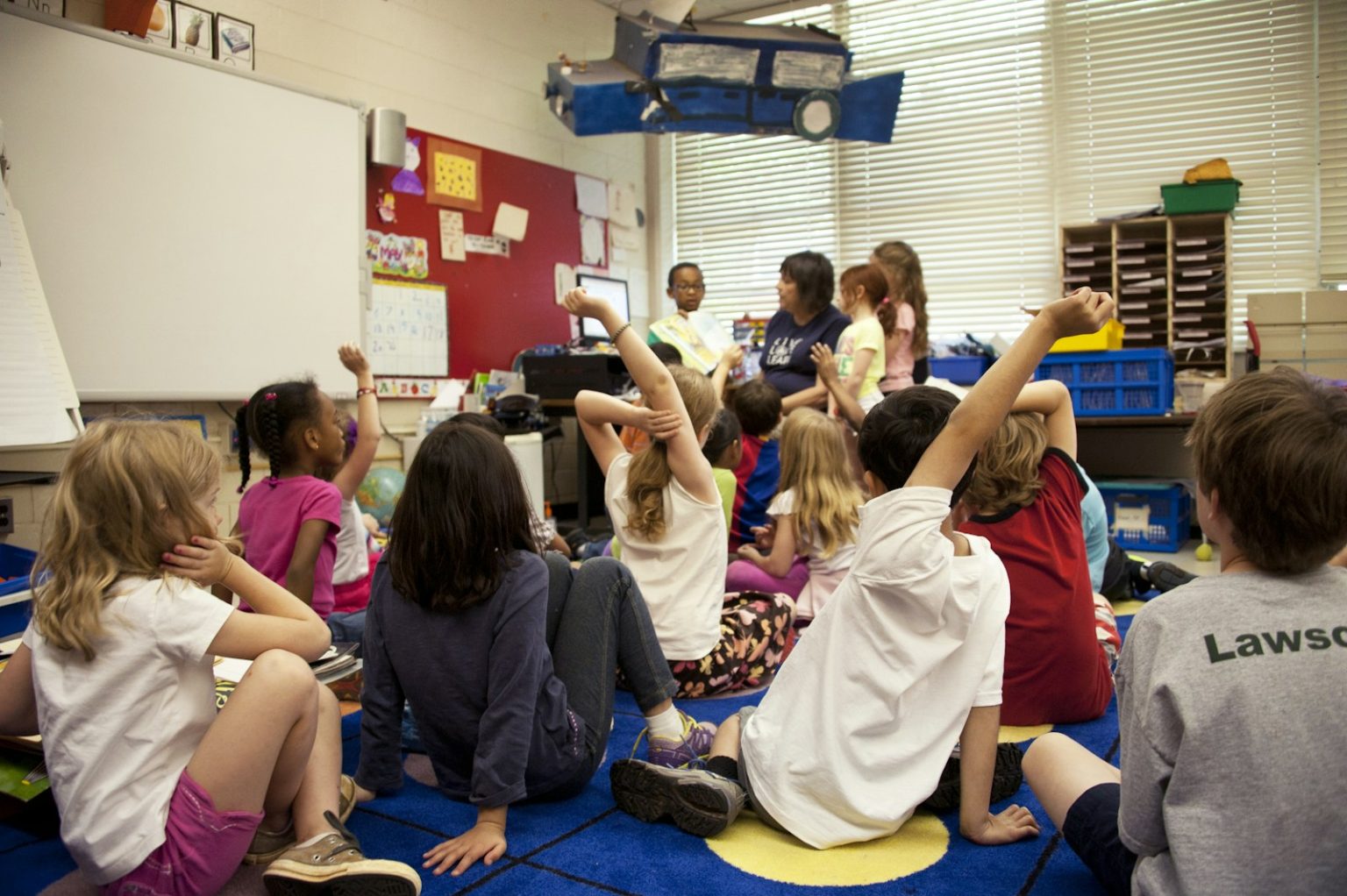 Venture Global Invests in Cameron Parish Education people sitting on blue carpet