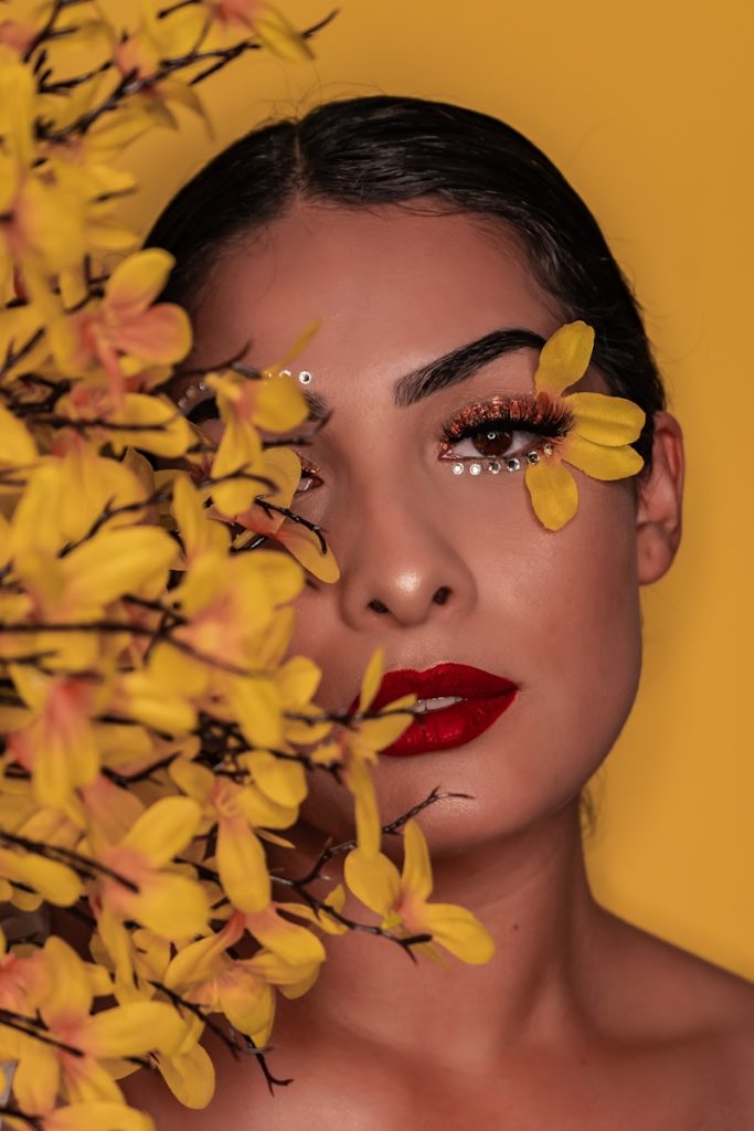 Free Free Brings £70M+ Impact Movement to the UK woman with red lipstick holding yellow flower