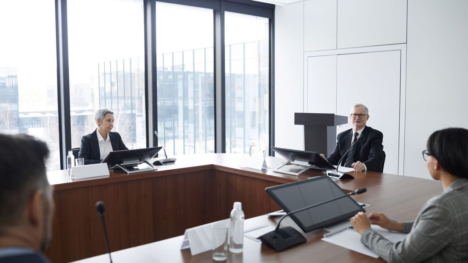 Parties seated around a conference table in a bright meeting room, illustrating enforcement Under the New York Convention Shapes International Business Dispute Strategy